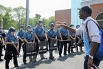 A resident of Ferguson speaks to Missouri State Highway Patrol officers in riot gear during a protest on Aug. 11