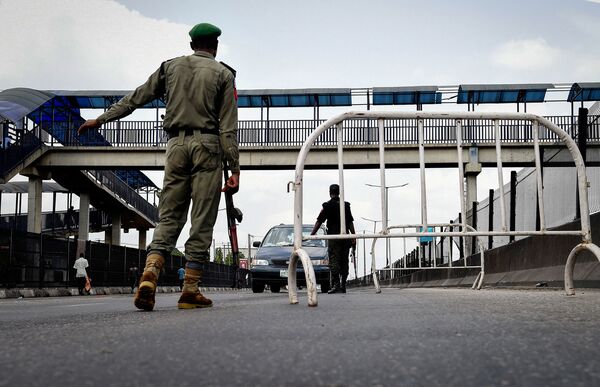 Nigerian police officers man a checkpoint in Lagos.