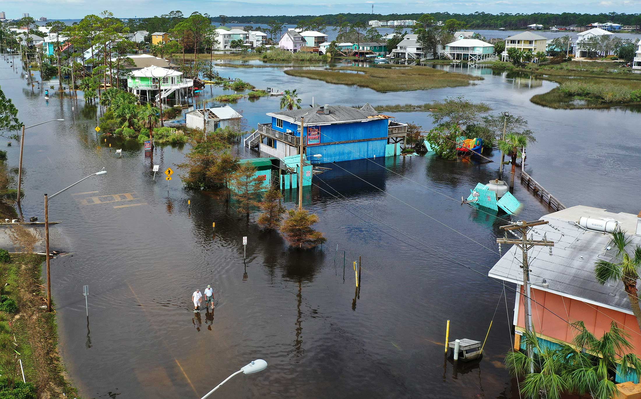 People walk through a flooded street after Hurricane Sally passed through&nbsp;Gulf Shores, Florida on Sept 17.