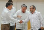 Colombian President Juan Manuel Santos and the head of the FARC guerrilla Timoleon Jimenez shake hands in front of Cuban President Raul Castro during a meeting in Havana on September 23.
