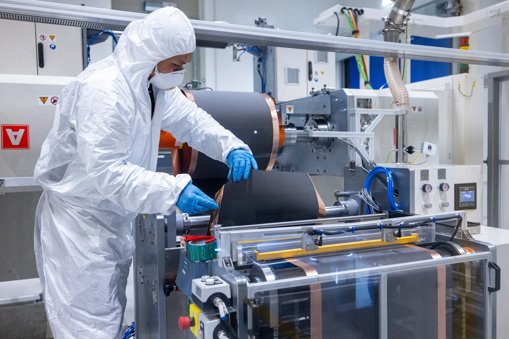 An employee inserts an anode coil at the PowerCo SE factory in Salzgitter, Germany, on Dec. 12.