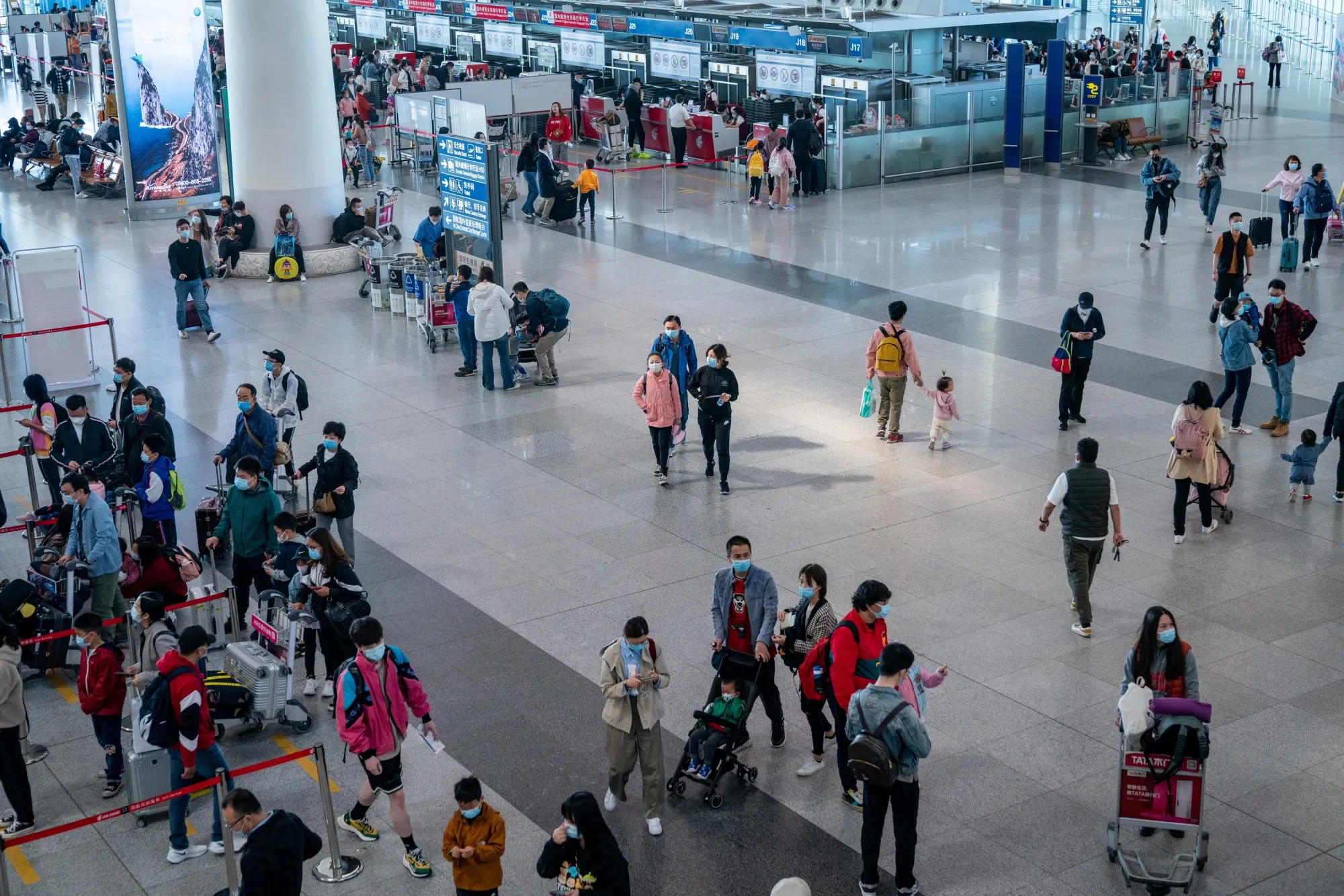 Travelers walk through Beijing Capital International Airport in Beijing, China.