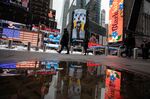 Pedestrians pass in front of the Nasdaq MarketSite during Bumble Inc.'s initial public offering in New York, U.S., on Feb. 11.