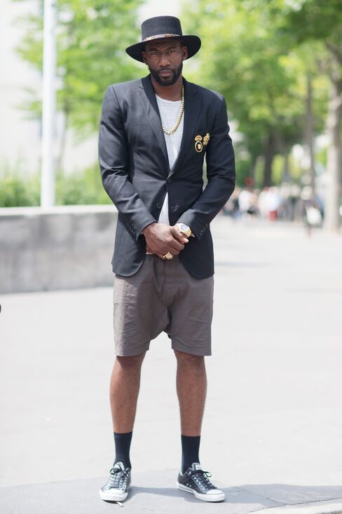 Amar'e Stoudemire outside of the Louis Vuitton show in Paris in a Saint Laurent hat, Ovadia & Sons jacket, Rolex watch, and Rick Owens shorts.