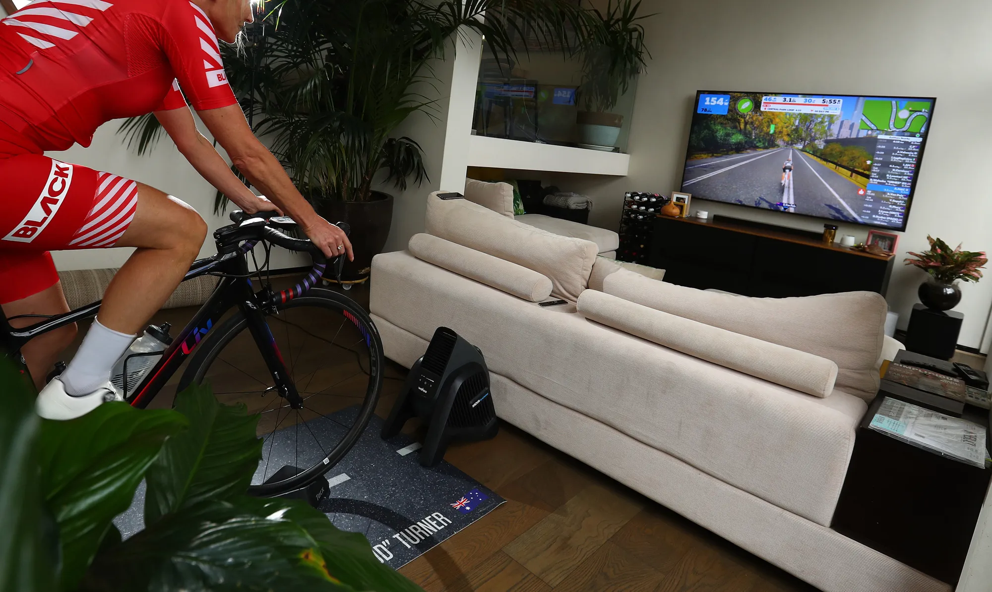 A cyclist uses Zwift in her living room  in Melbourne, Australia.