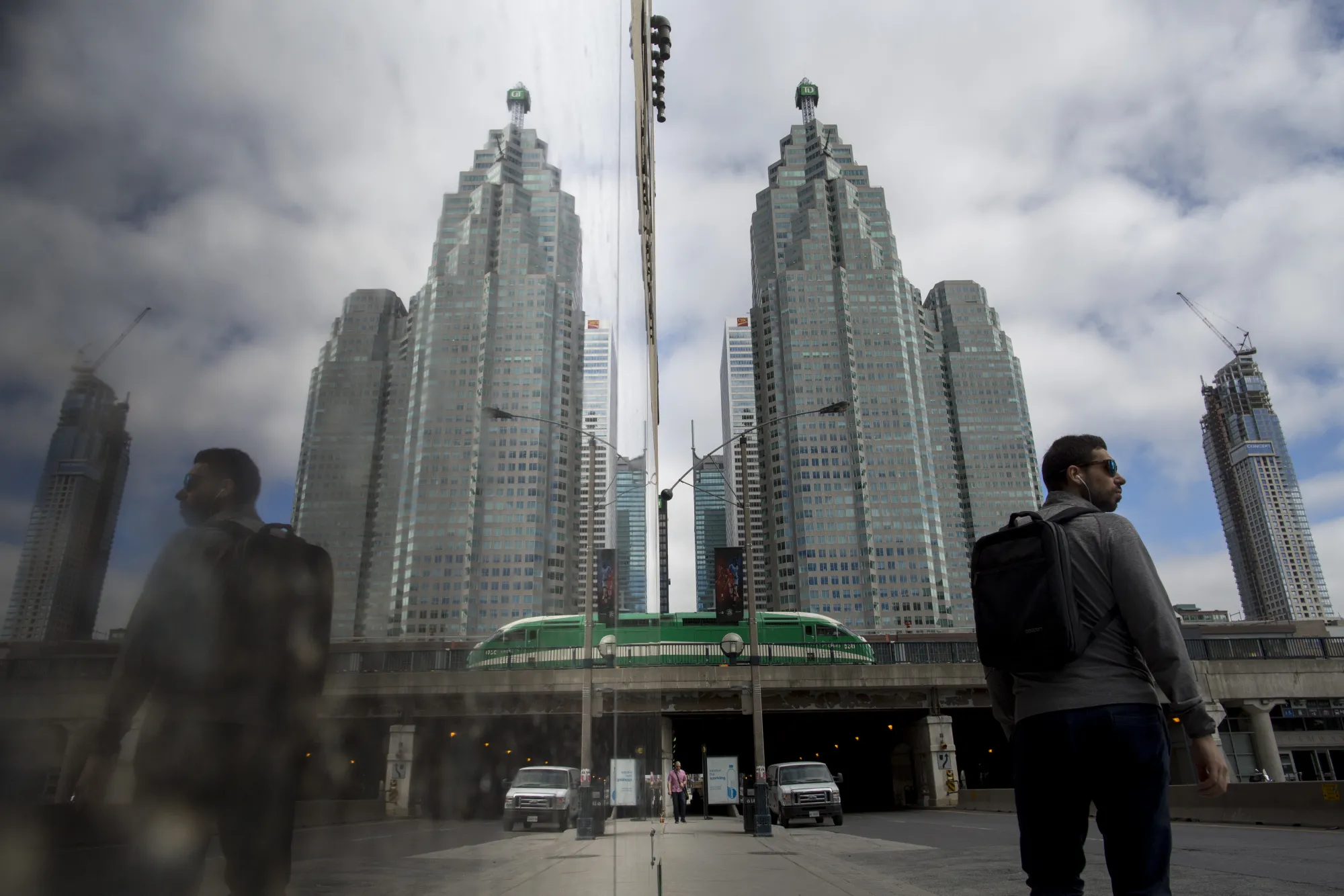 A pedestrian stands in front of a Toronto-Dominion Bank&nbsp;building in Toronto.
