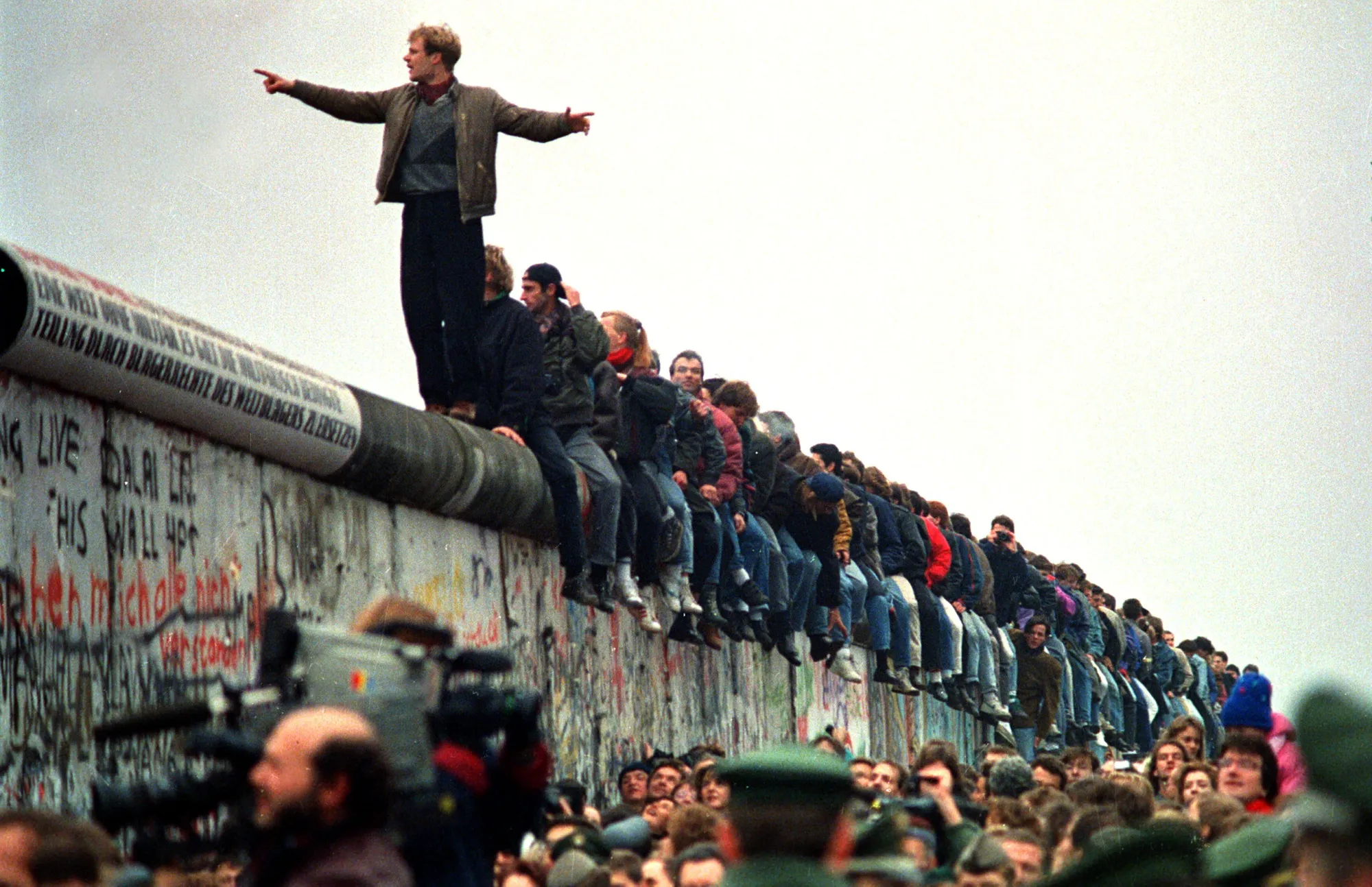 Berliners bestride the Berlin Wall at Potsdamer Platz on Nov, 11, 1989.