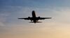 Approaching passenger aircraft at sunset