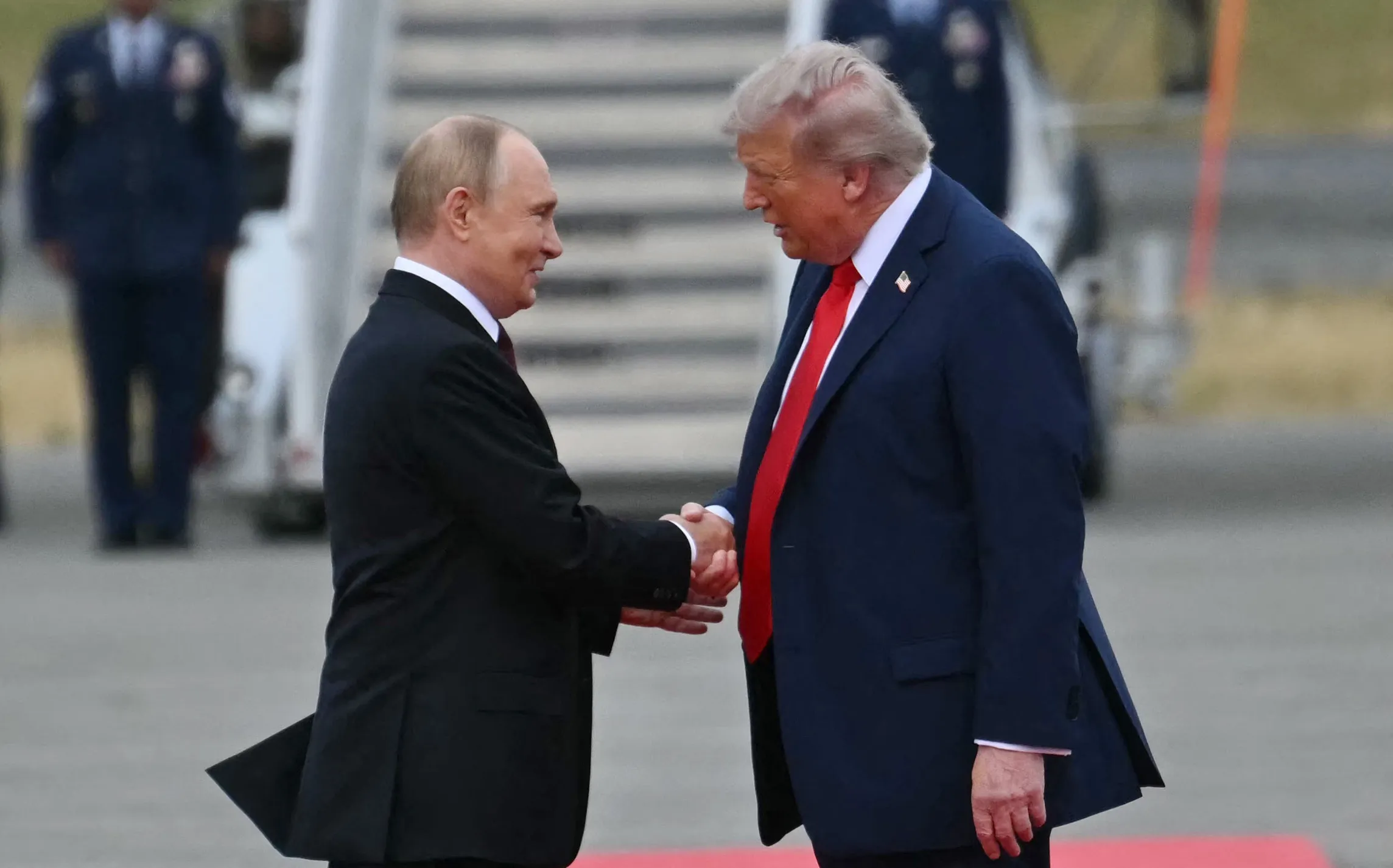 US President Donald Trump greets Russian President Vladimir Putin on the tarmac after they arrived at Joint Base Elmendorf-Richardson in Anchorage, Alaska.