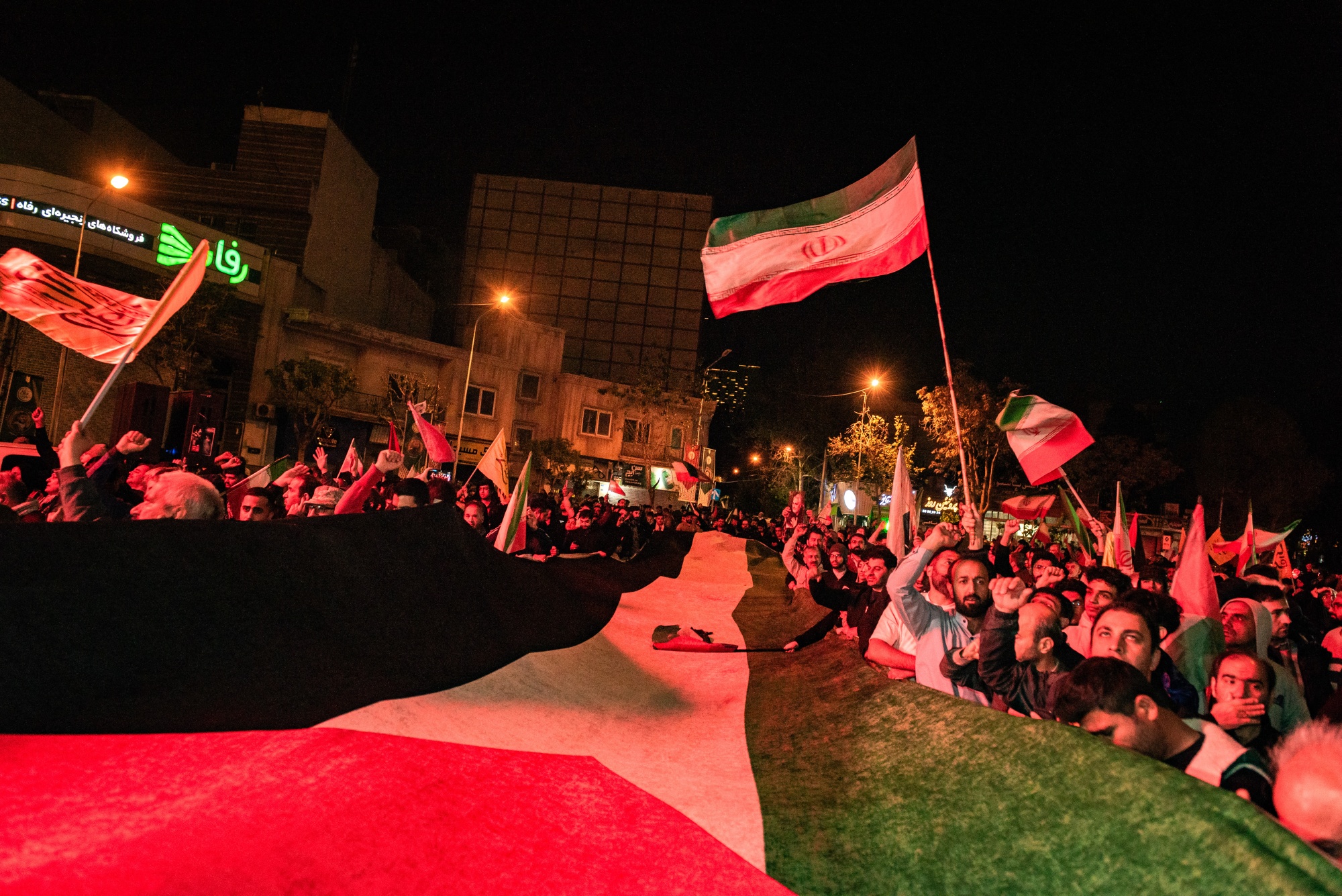 Iranian pro-government supporters hold a giant Palestine flag at Palestine Square in Tehran, on April 14.
