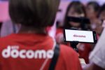 The NTT Docomo Inc. logo is displayed on a screen of a prototype of a smartphone used for the 5G network technology experience.