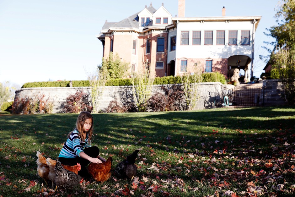 A girl plays with her chickens in St. Joseph, Missouri. 