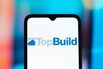 In this photo illustration, the TopBuild (Top Build) logo is