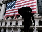 People walk in front of the New York Stock Exchange (NYSE) on March 17, 2020 in New York City.
