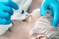 Woman Having Botox Injected In Her Face