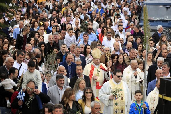 Lebanese Christians attend a traditional Palm Sunday procession in Rmeish in March 2024.
