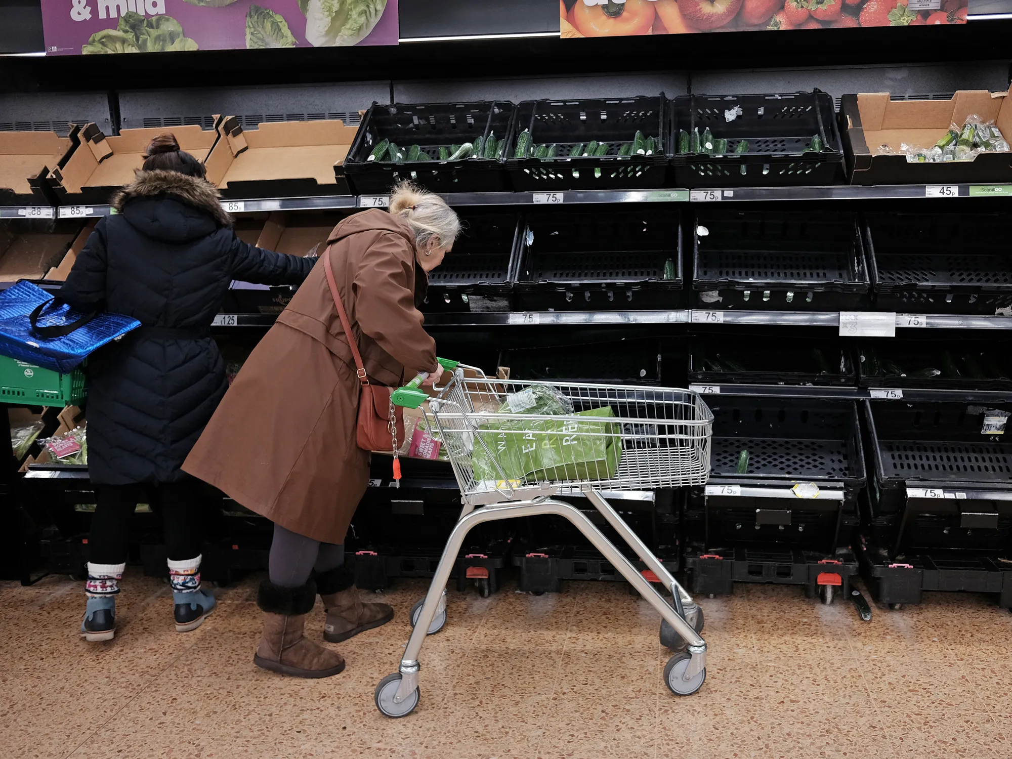 Empty fruit and vegetable shelves at an Asda store in London.