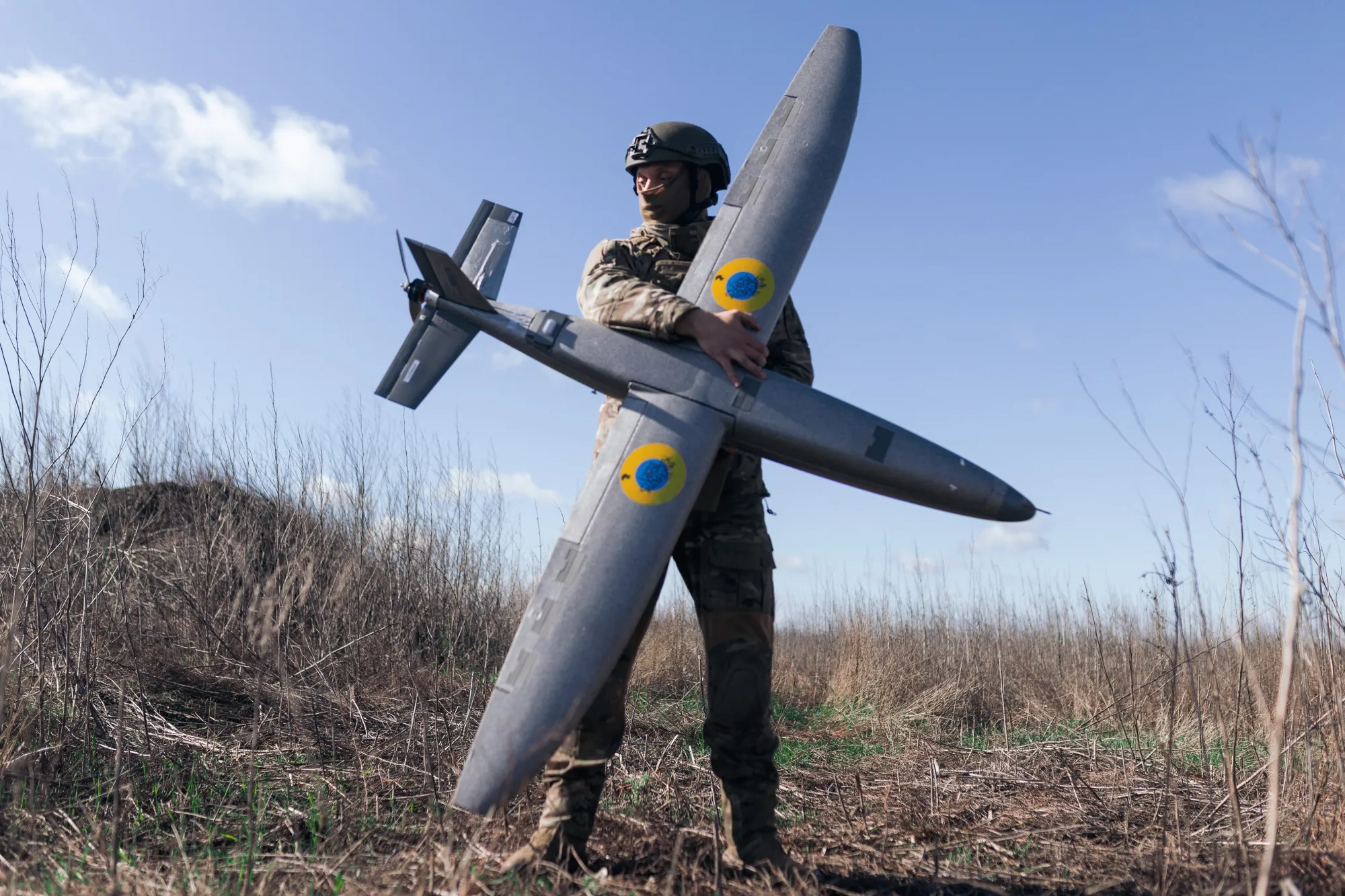 A soldier from an unmanned aerial vehicle unit holding an attack drone in Kharkiv region.