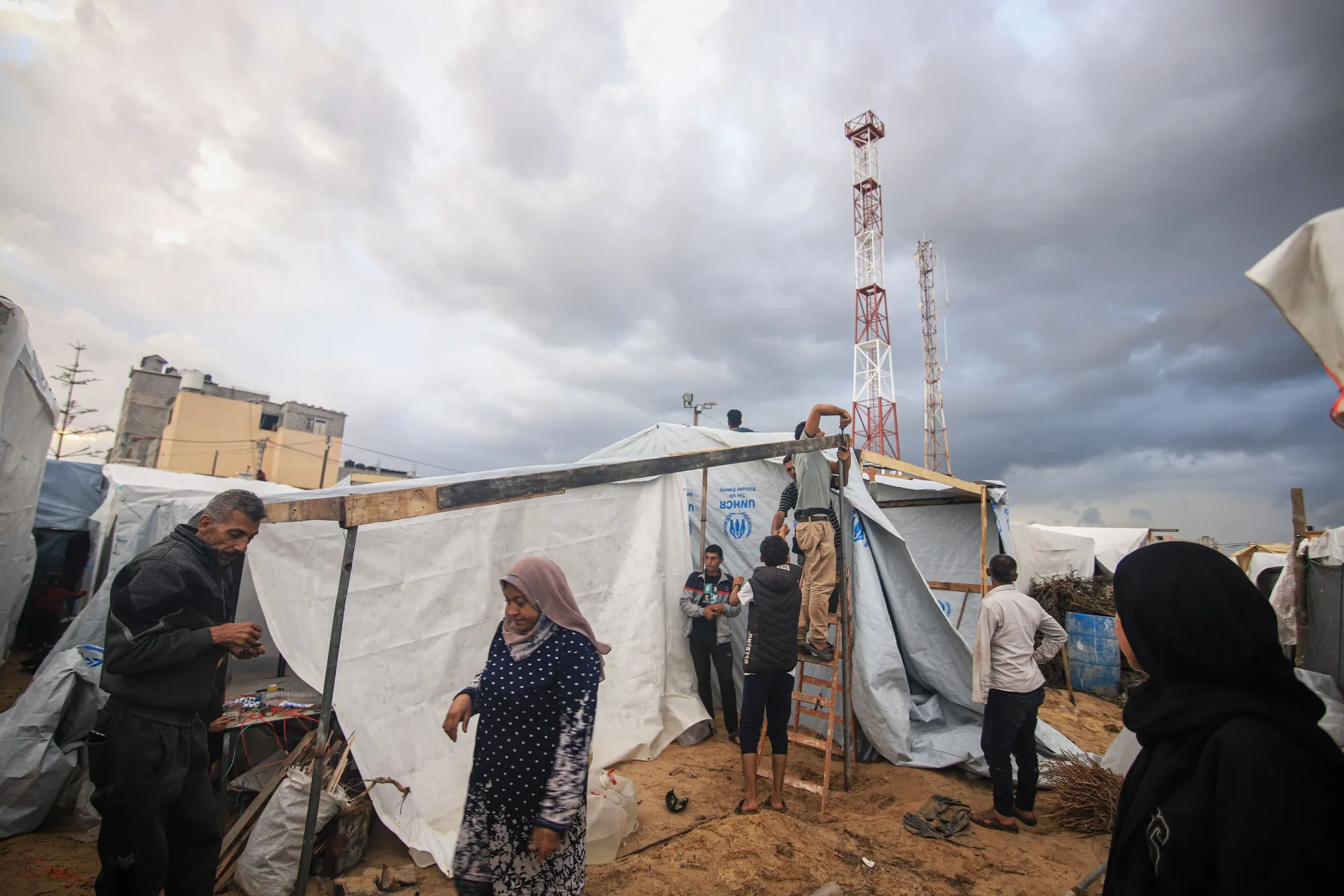 Displaced Palestinians build temporary shelters at a camp operated by UNWRA, in Khan Younis, Gaza.