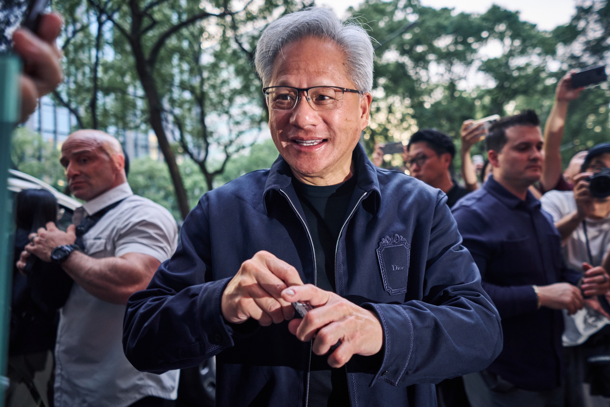 Jensen Huang, chief executive officer of Nvidia Corp., signs autographs as he arrives for a dinner event in Taipei, Taiwan, on Thursday, May 28, 2026. The event, dubbed “The Trillion Dollar Banquet,” is a regular dinner hosted by Huang when he visits his Taiwanese partners.
