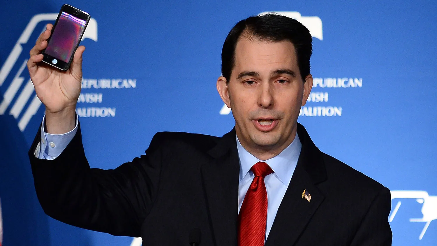 Wisconsin Gov. Scott Walker holds up his cell phone as he speaks during the Republican Jewish Coalition spring leadership meeting at The Venetian Las Vegas on March 29, 2014 in Las Vegas, Nevada.
