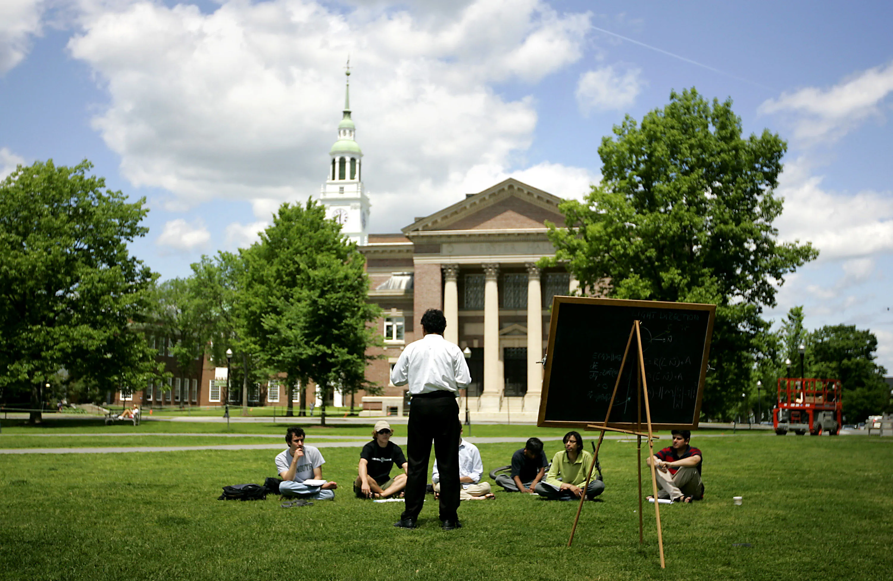 A group of students meet on the lawn outside Webster Hall on the campus of Dartmouth College, the smallest school in the Ivy League, in Hanover, New Hampshire.
