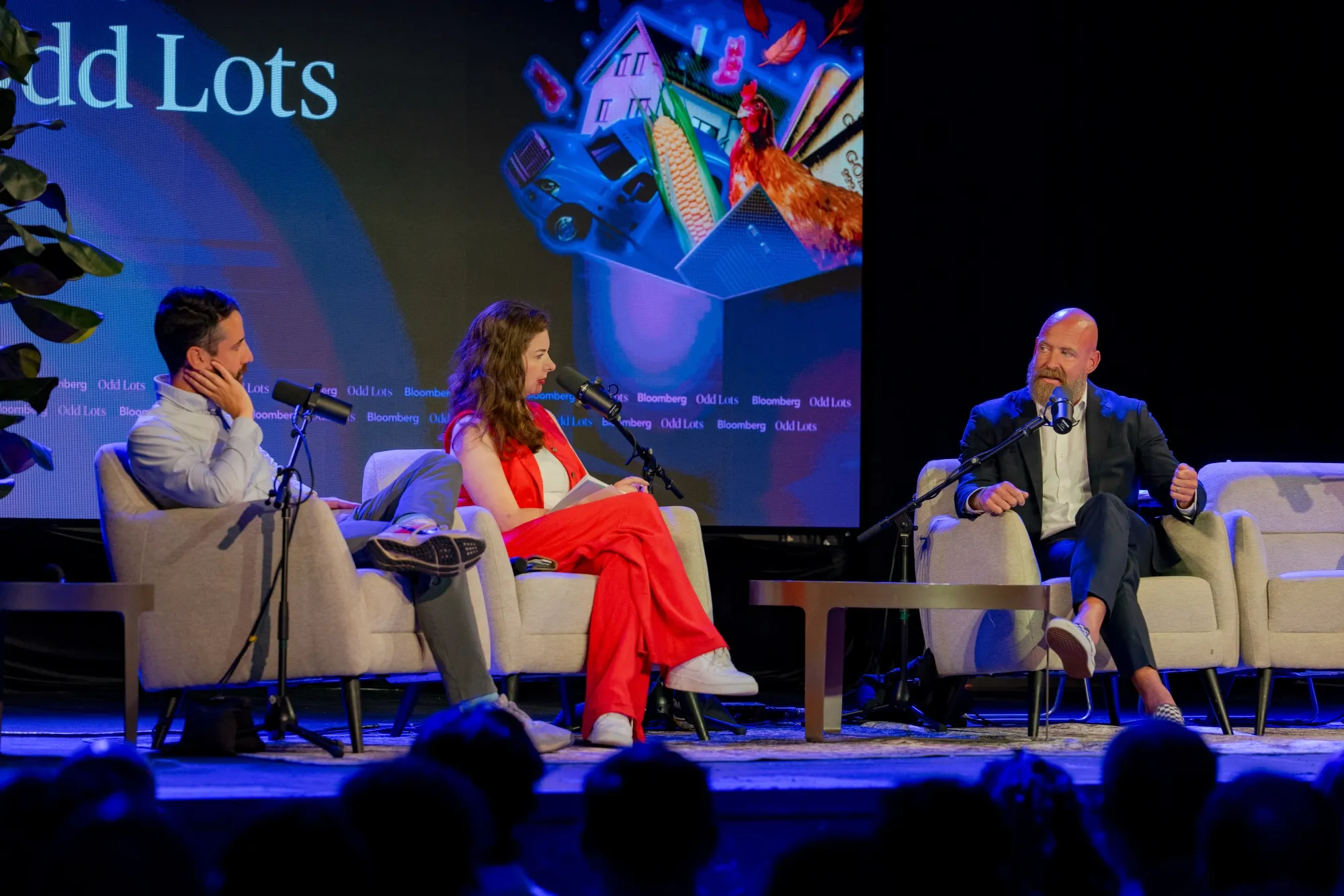 Joe Weisenthal, Tracy Alloway, and Charlie McElligot onstage at the Odd Lots live taping on July 26, 2025.