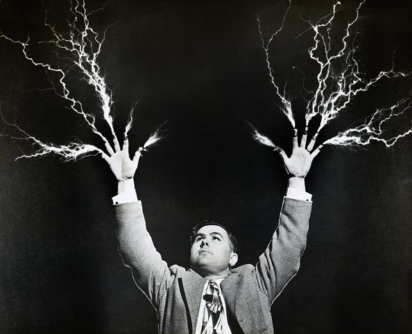 Electricity shooting through the fingers of a man'
