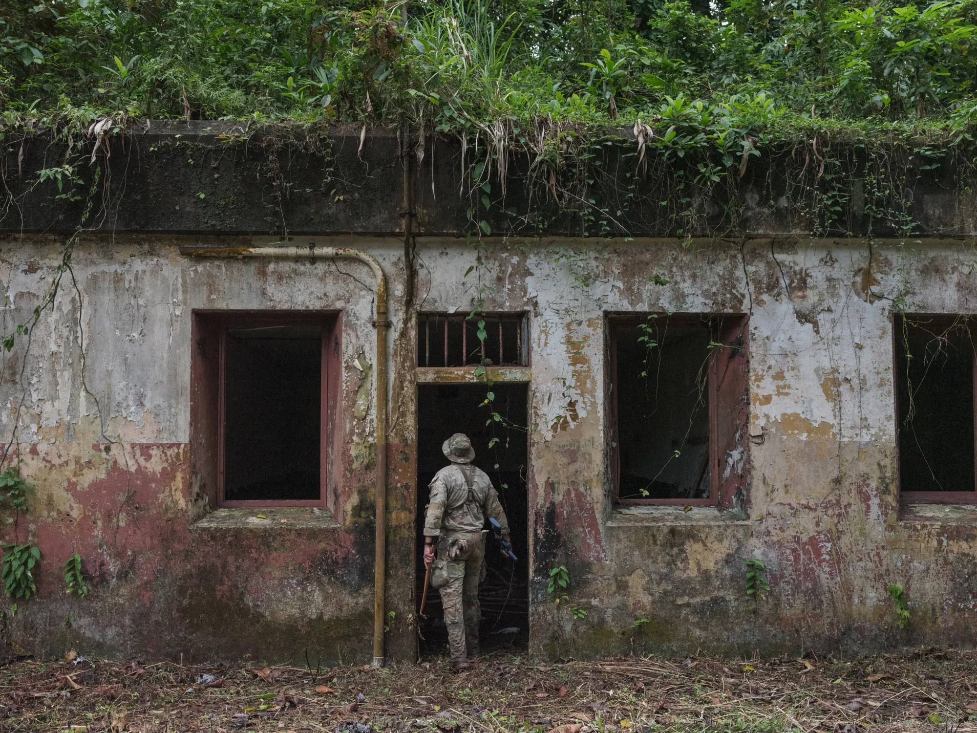 A US Army solider enters a former bunker during training as the US revives its jungle training school near Colón, Panama, in February.