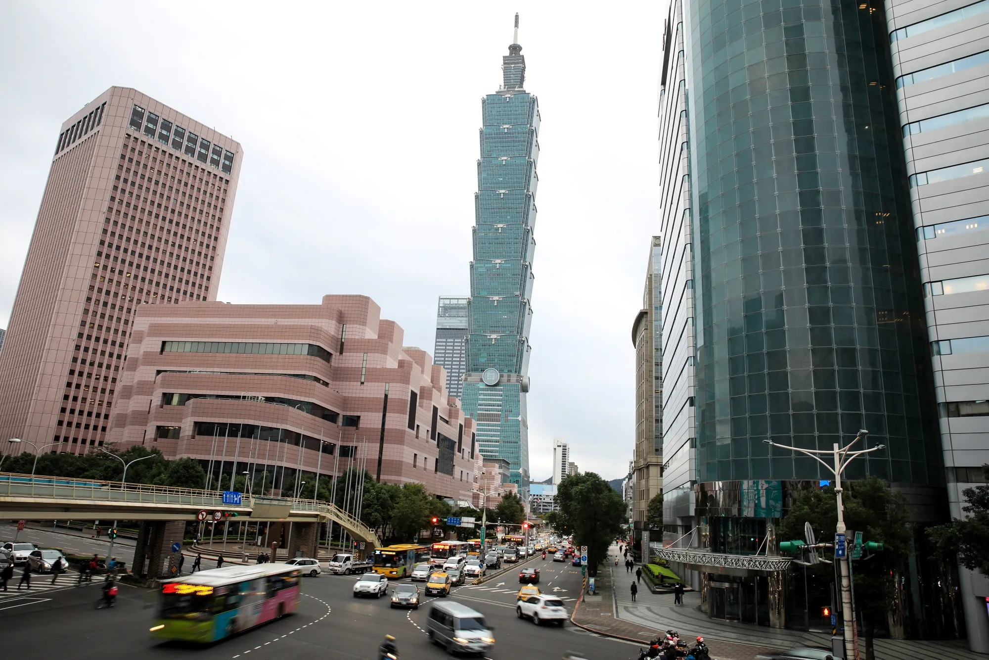 Vehicles travel along a road in front of the Taipei 101 building, center, in Taipei, Taiwan.