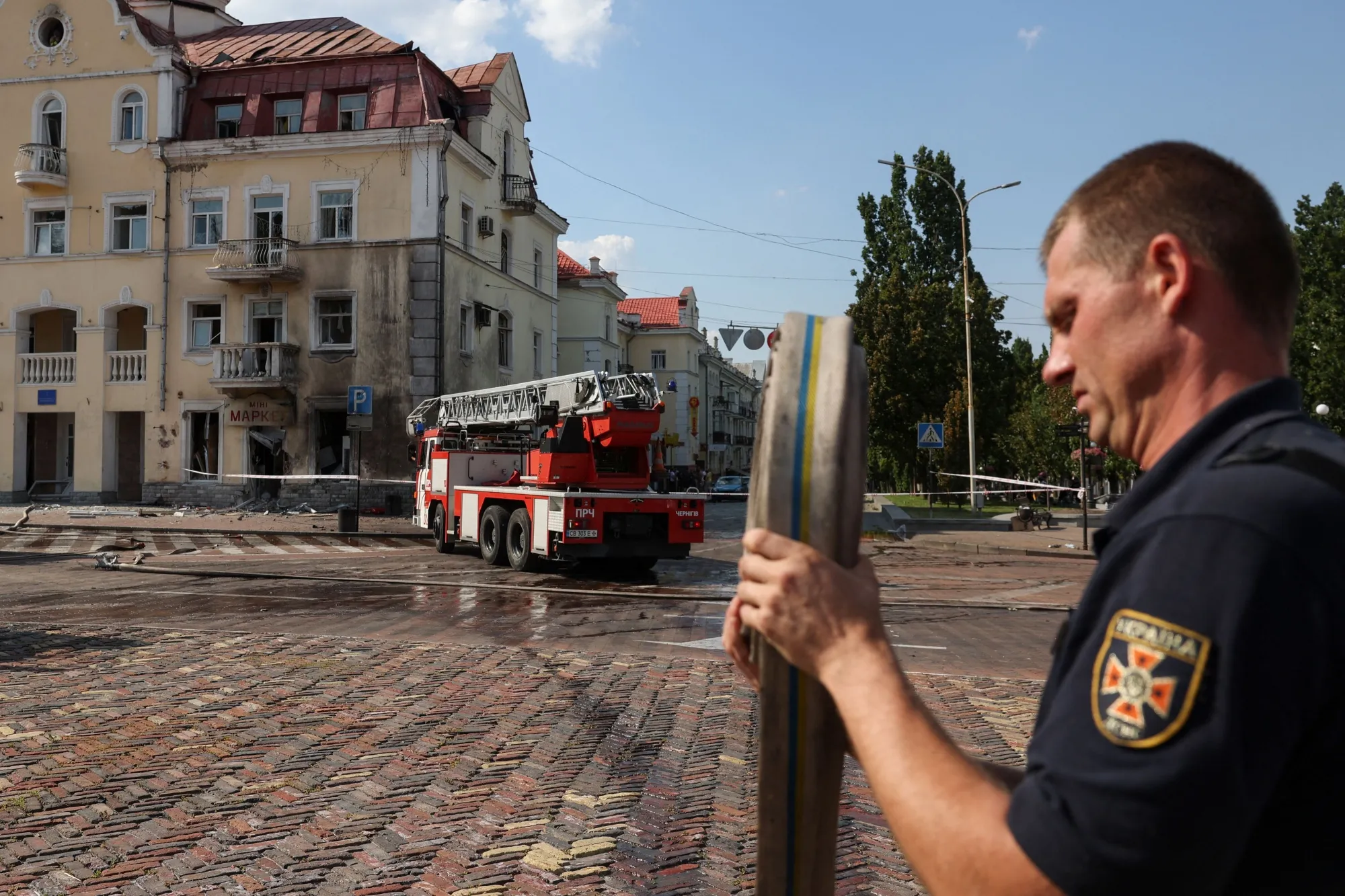 A Ukrainian firefighter works at the site of a missile strike in Chernihiv, on Aug. 19, 2023. 