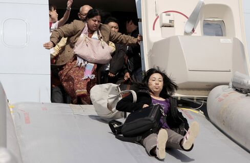 Passengers are evacuated from a Cathay Pacific Boeing 747 aircraft that aborted its takeoff from Shanghai Pudong airport in 2011 after smoke was detected.