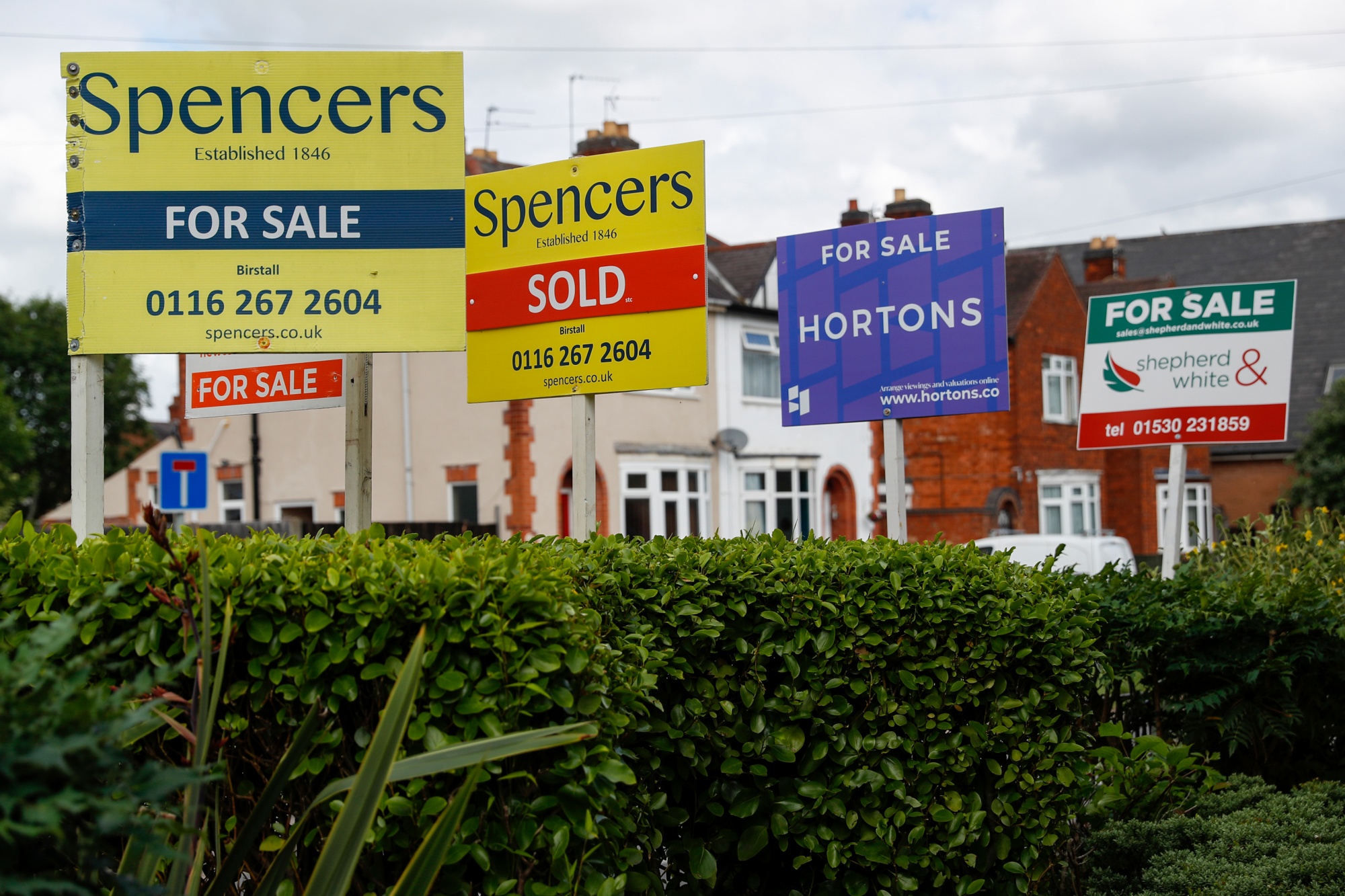 Estate agent 'for sale' boards outside a block of flats in Birstall, U.K.