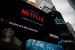 Netflix signage next to the Nasdaq MarketSite in New York, U.S., on Friday, Jan. 21, 2022. 