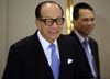 Billionaire Li Ka-shing, chairman of Cheung Kong Holdings Ltd. and Hutchison Whampoa Ltd., and Victor Li, deputy chairman of Cheung Kong and Hutchison Whampoa, leave a news conference in Hong Kong, China, on Friday, Jan. 9, 2015. Cheung Kong Holdings offered $24 billion in stock to buy out unit Hutchison Whampoa and will spin off its property assets in the biggest reorganization of Hong Kong billionaire Li's corporate empire.