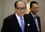 Billionaire Li Ka-shing, chairman of Cheung Kong Holdings Ltd. and Hutchison Whampoa Ltd., and Victor Li, deputy chairman of Cheung Kong and Hutchison Whampoa, leave a news conference in Hong Kong, China, on Friday, Jan. 9, 2015. Cheung Kong Holdings offered $24 billion in stock to buy out unit Hutchison Whampoa and will spin off its property assets in the biggest reorganization of Hong Kong billionaire Li's corporate empire.