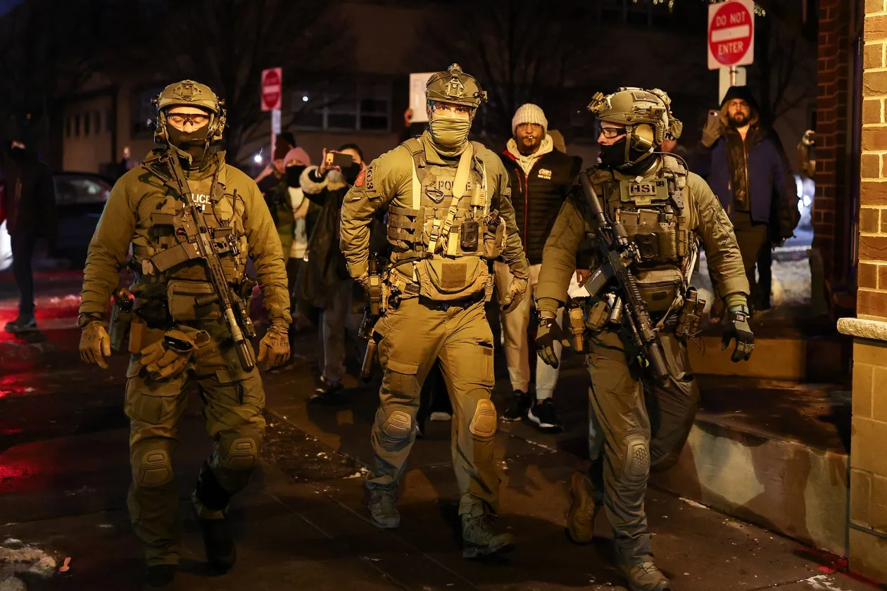 Federal agents with Homeland Security Investigations depart the area outside a residential building in Minneapolis on Feb. 5.