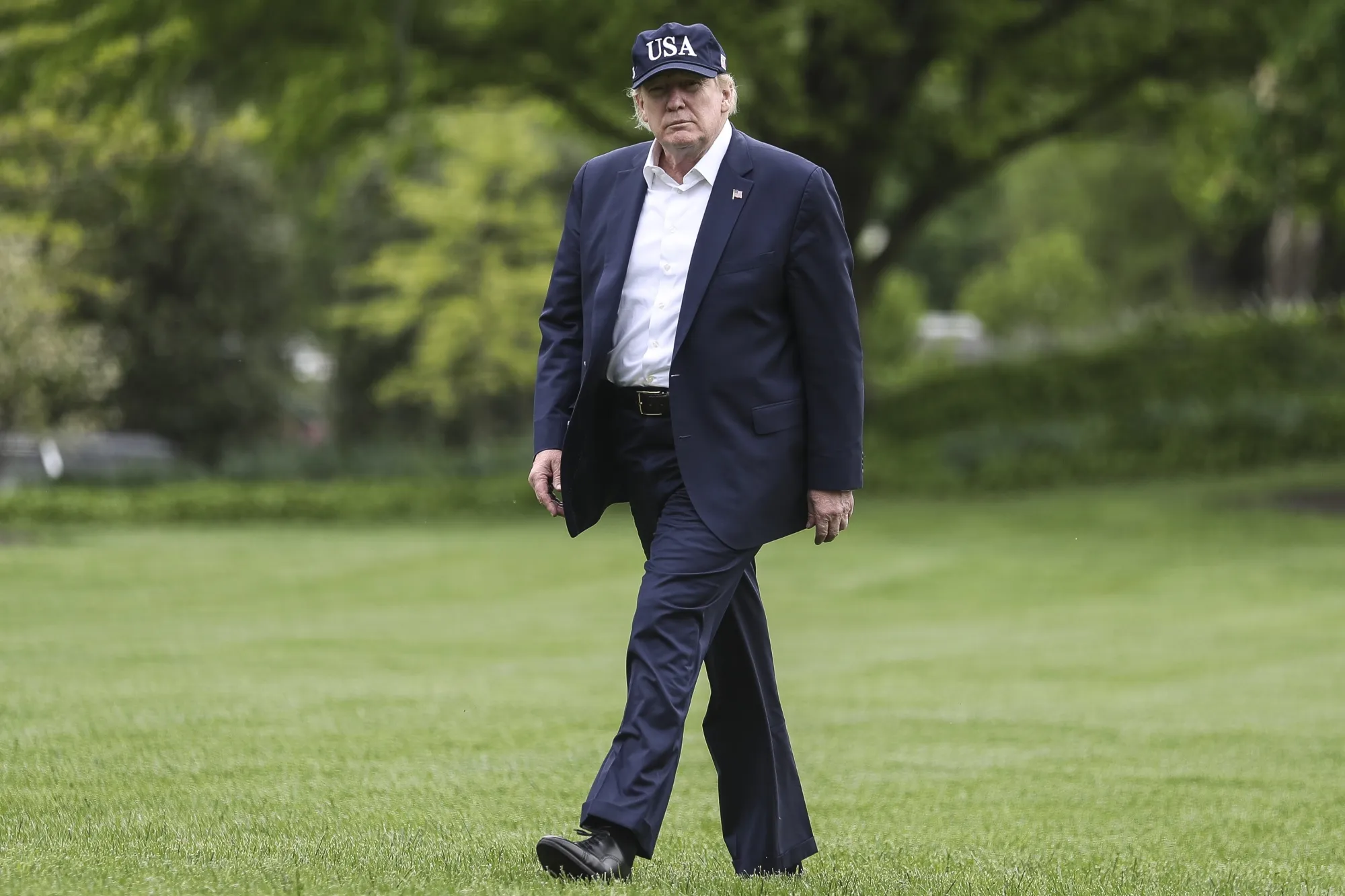 Donald Trump walks on the South Lawn of the White House.