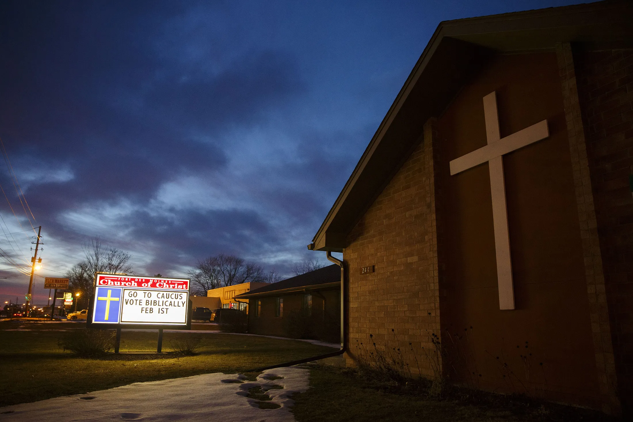 A marquee with the phrase 'Go To Caucus Vote Biblically' is seen outside the Fort Des Moines Church of Christ during a Wednesday night service.
