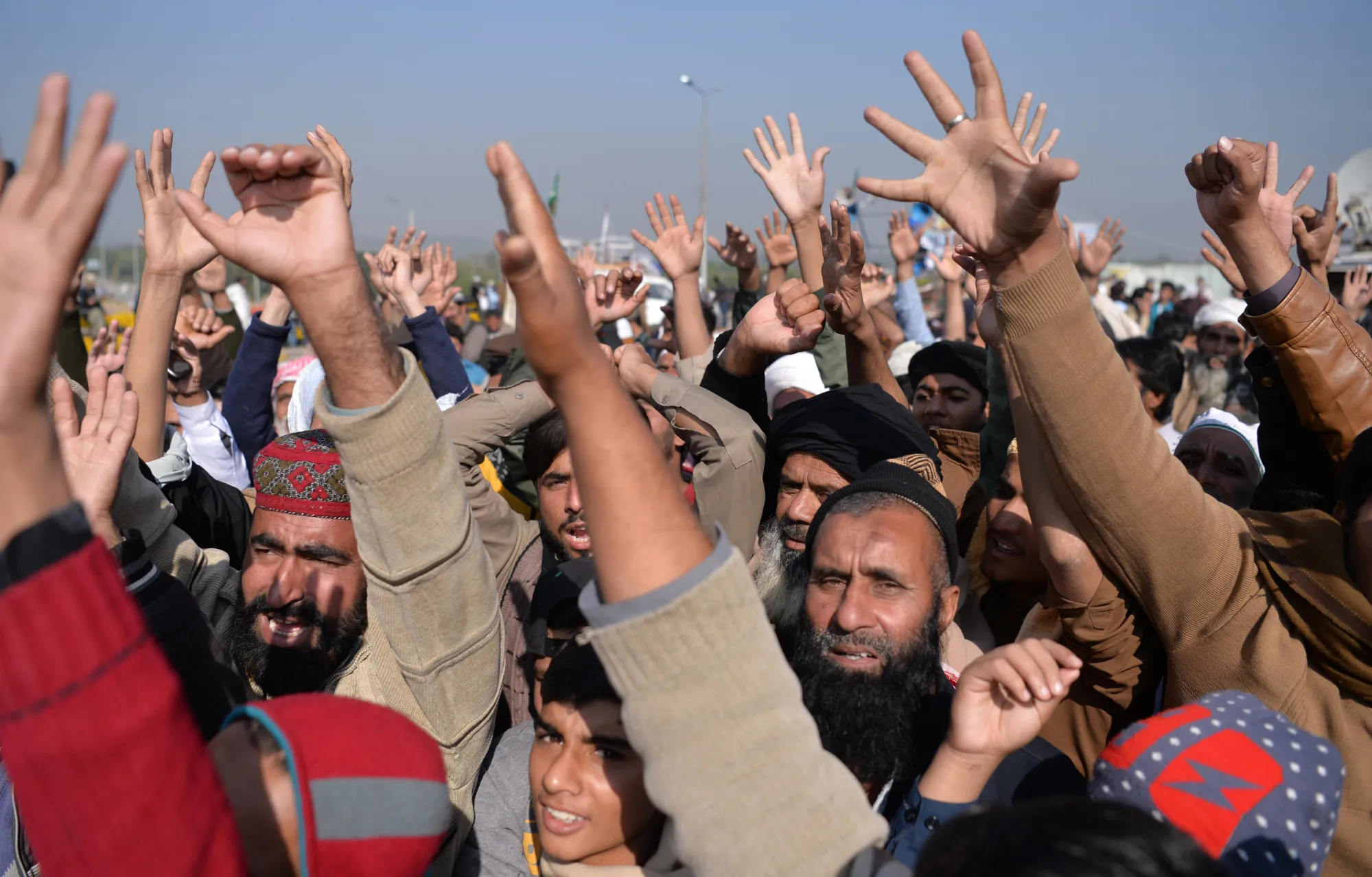 Pakistani activists from the Tehreek-i-Labaik Yah Rasool Allah Pakistan (TLYRAP) religious group chant slogans during a protest in Islamabad on November 20, 2017. Protesters from a hardline religious group blocking the main highway into Islamabad for the third week running on November 20, have threatened a complete chaos in the country as the government has failed to clear the situation. / AFP PHOTO / AAMIR QURESHI (Photo credit should read AAMIR QURESHI/AFP/Getty Images)