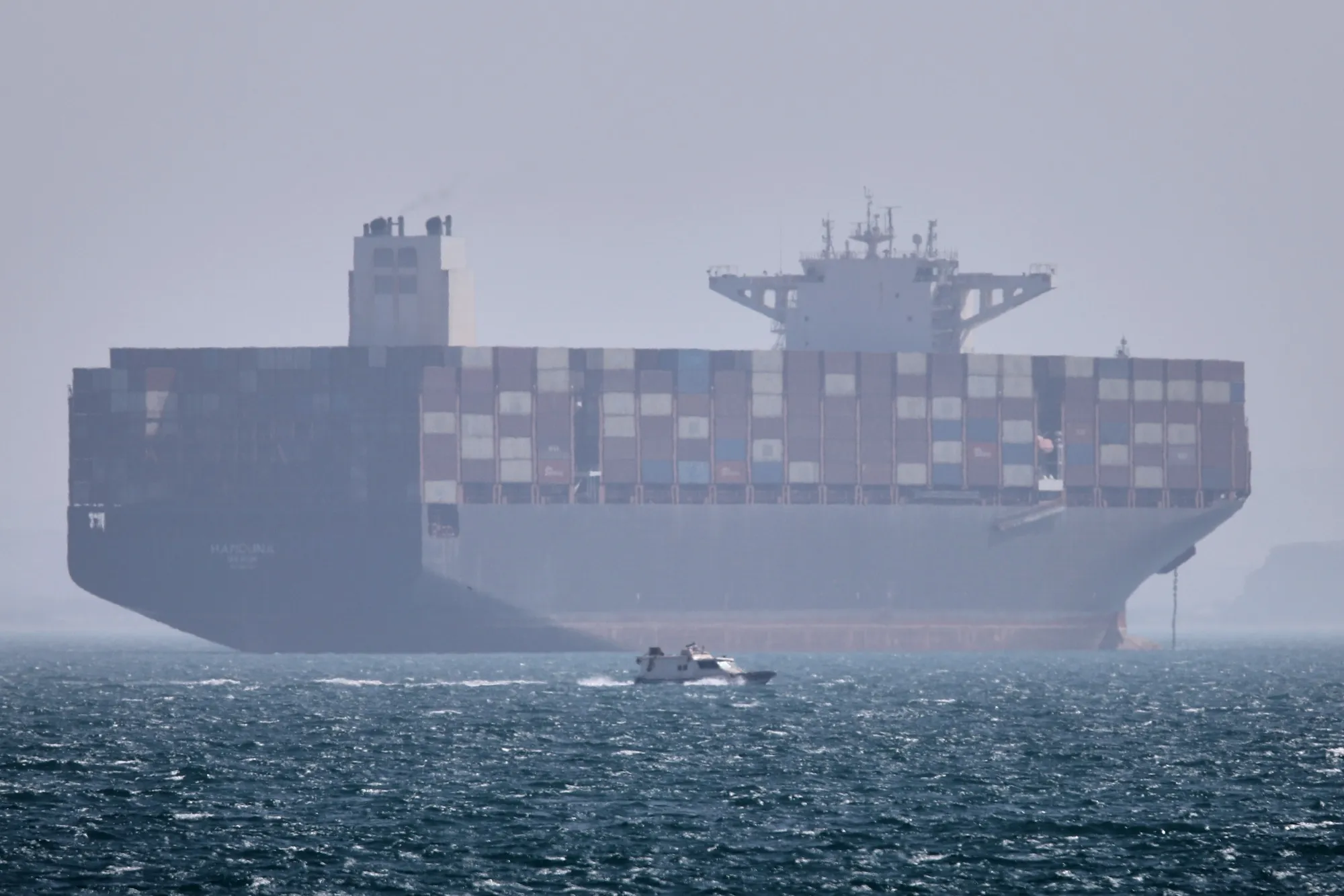 A container ship sits at anchor in the Strait of Hormuz.