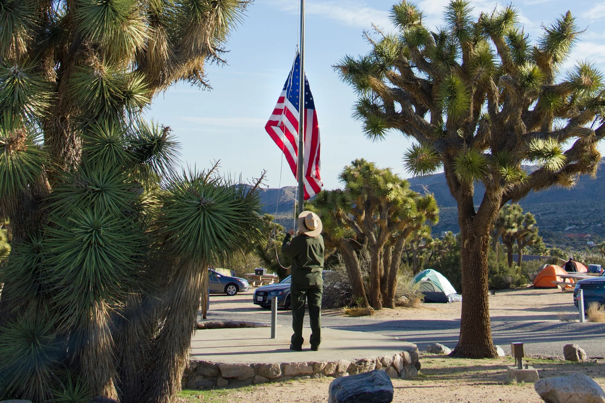 A ranger raising the flag at Black Rock Campground, Joshua Tree National Park, in 2015.