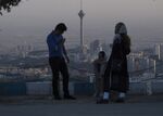 Iranians enjoy the late evening view of the city skyline and the Milad Tower, also known as the Tehran Tower, center, from Tochal mountain in Tehran.
