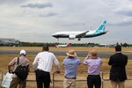 Spectators watch a Boeing Co. 737 Max 7 jetliner land on the opening day of the Farnborough International Airshow 2018 in Farnborough, U.K., on July 16.