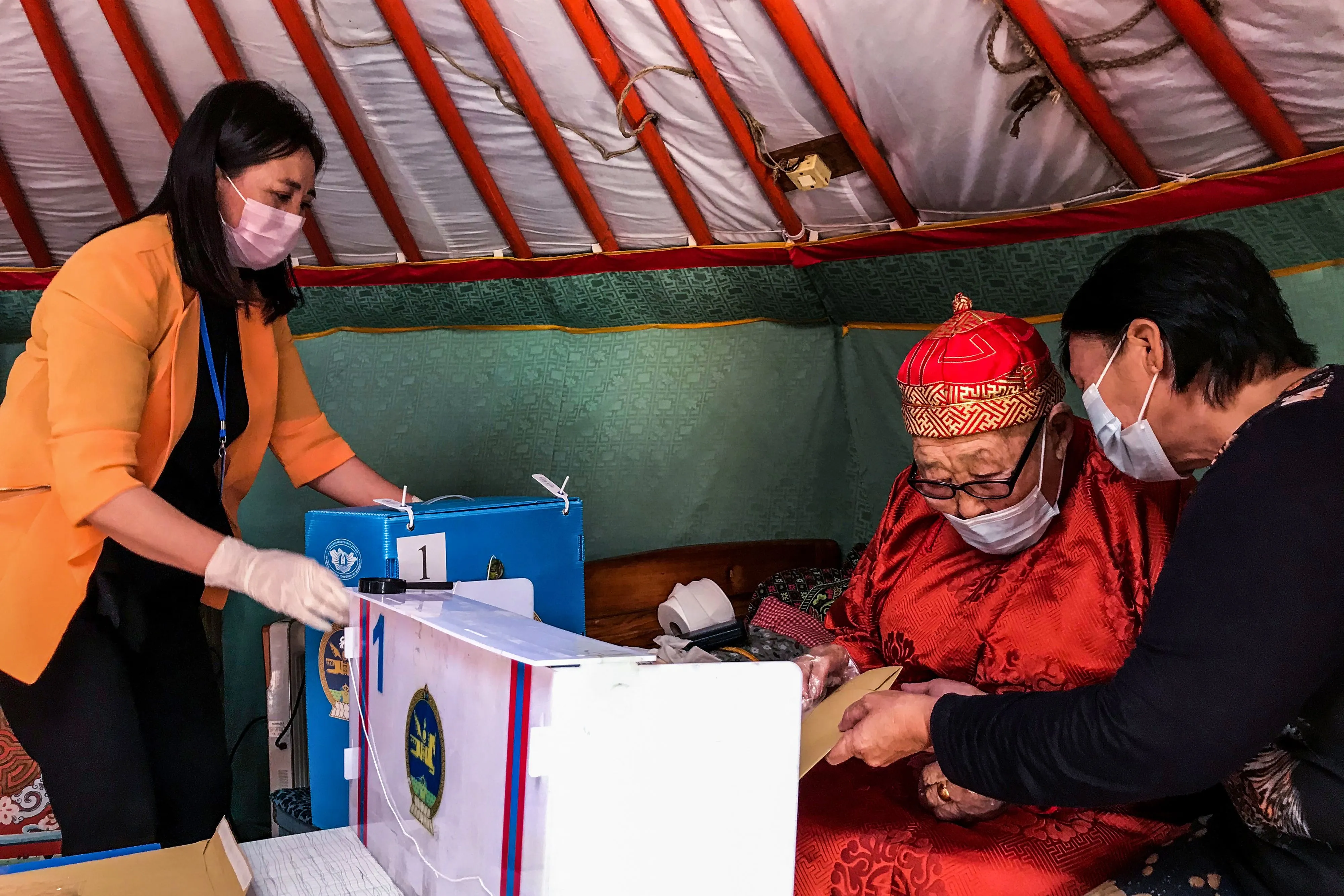 An elderly resident prepares to vote at his home in Ulaanbaatar on June 23.