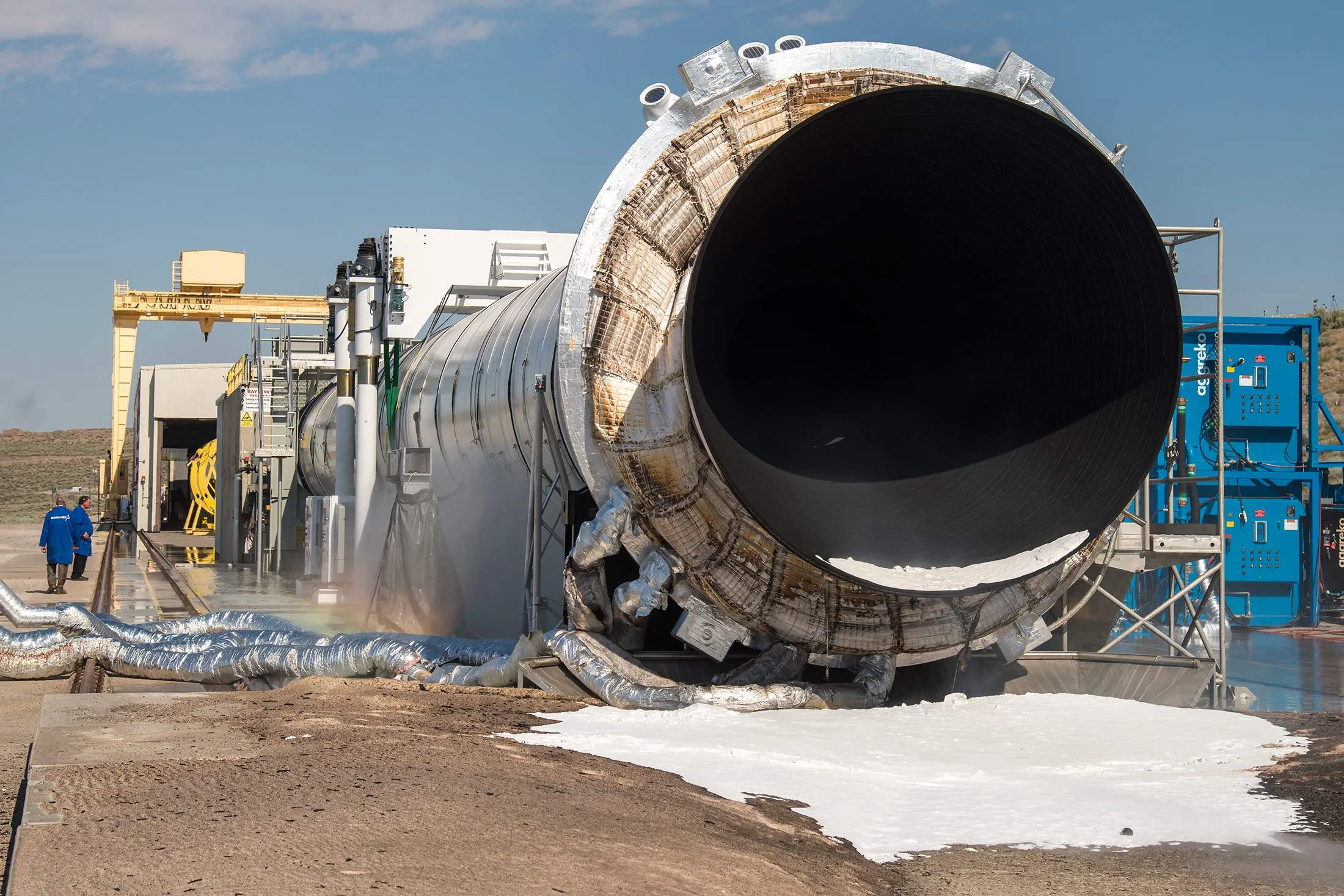 The Space Launch System’s booster is seen after the second and final qualification motor (QM-2) test, Tuesday, June 28, 2016, at Orbital ATK Propulsion Systems test facilities in Promontory, Utah. During the Space Launch System flight the boosters will provide more than 75 percent of the thrust needed to escape the gravitational pull of the Earth, the first step on NASA’s Journey to Mars. Photo Credit: (NASA/Bill Ingalls)
