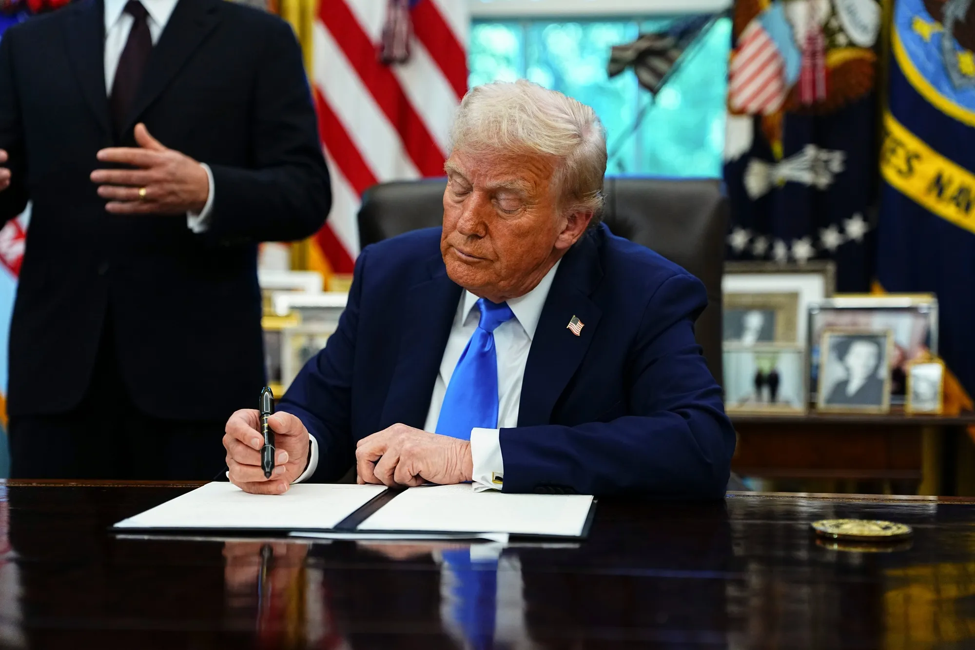 Donald Trump signs an executive order authorizing the Trump Gold Card at the White House in Washington, DC, on Sept. 19.