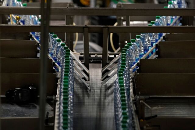 Bottled water moves along a conveyor belt at a manufacturing facility.