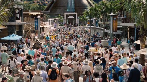 Jurassic World's visitors, enjoying the park's 79-degree weather and passing popular retail stores such as Oakley and Brookstone. Source: Universal Pictures' Jurassic World Featurette, © Universal Pictures/YouTube via Bloomberg