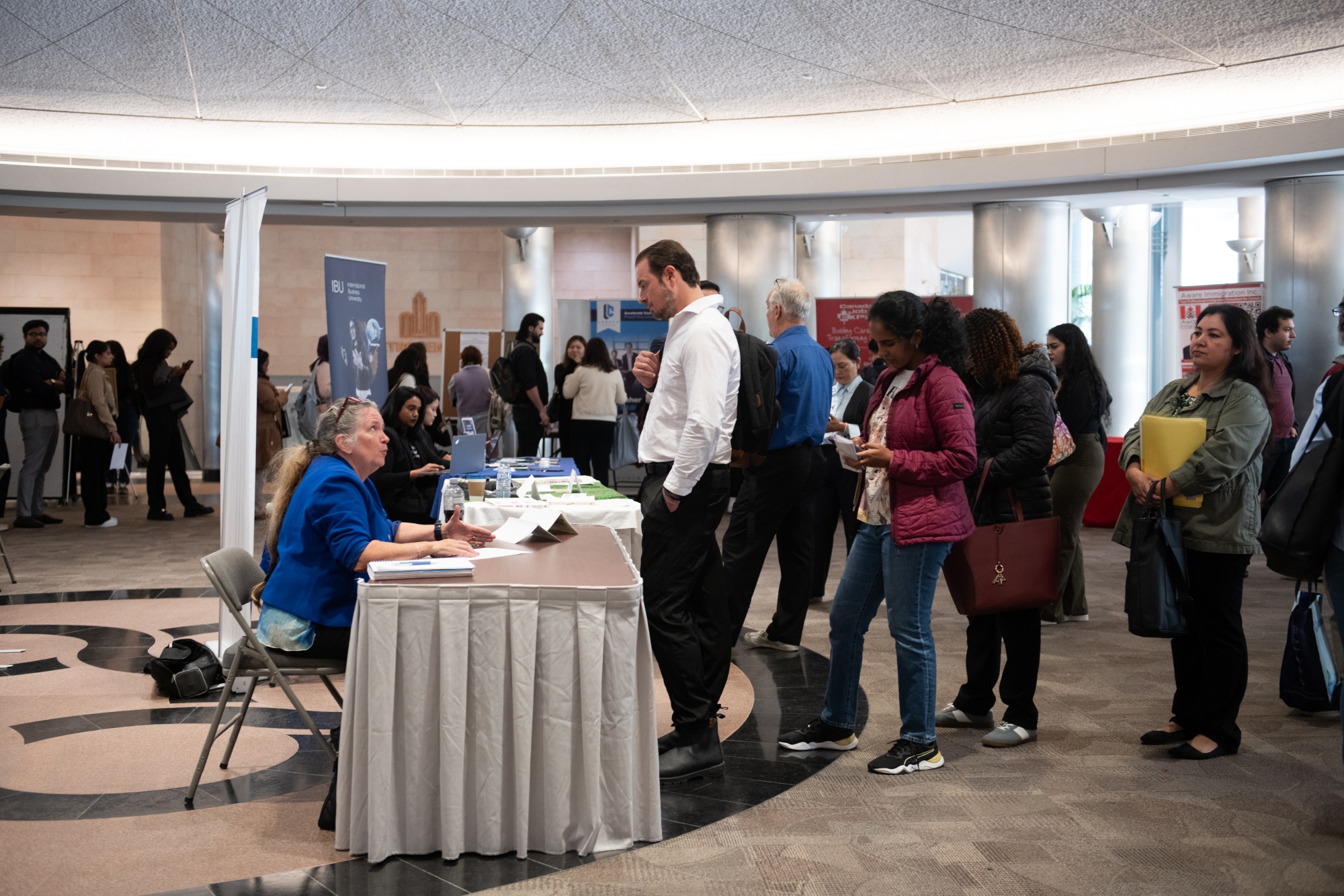 Jobseekers line up to receive help with resumes at the Canada Job Expo in Toronto.